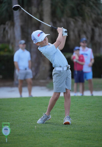 Young golfer tees off with driver