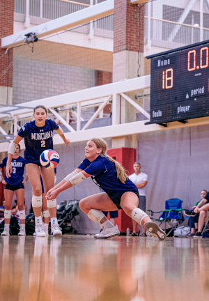 Young woman returning volleyball